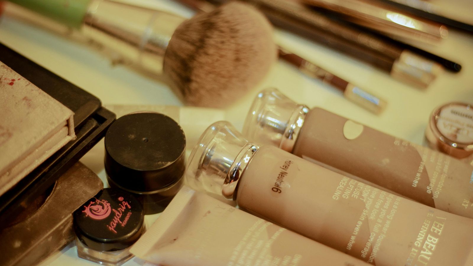 A woman's face with soft natural makeup in warm light