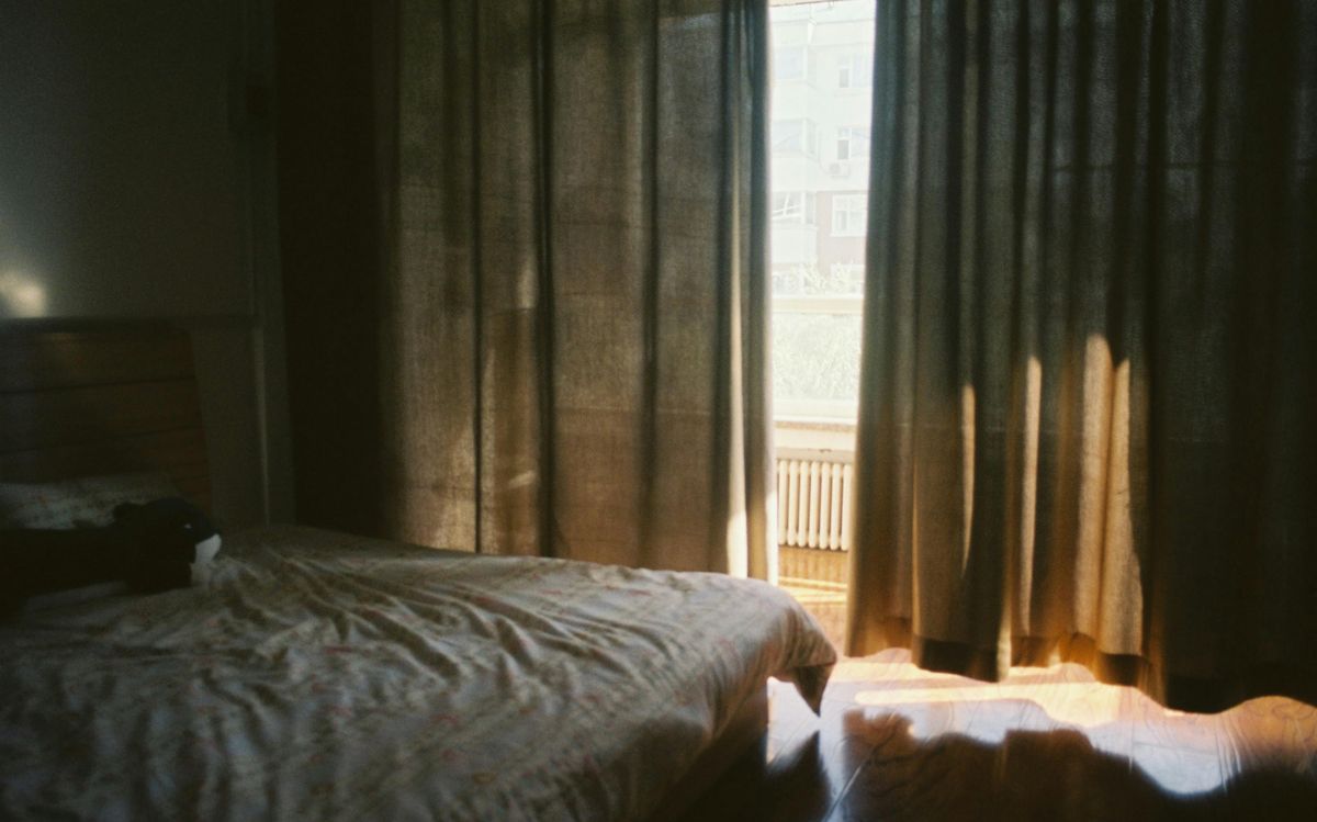 Morning sunlight spilling through a bedroom window