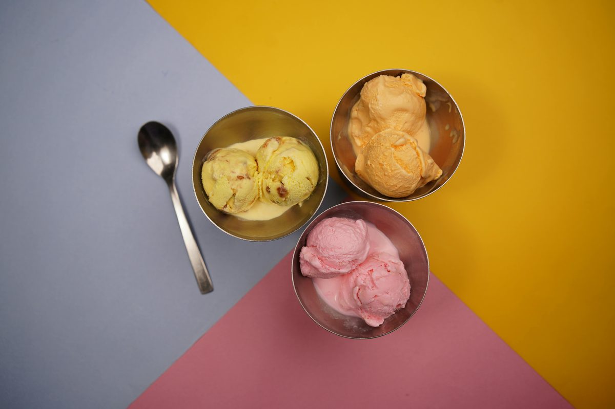 A scoop of creamy ice cream in a small glass bowl
